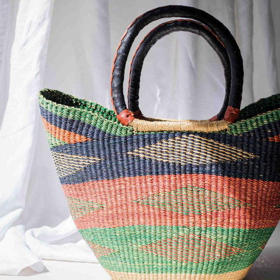 Woven basket with colorful pattern on a white background