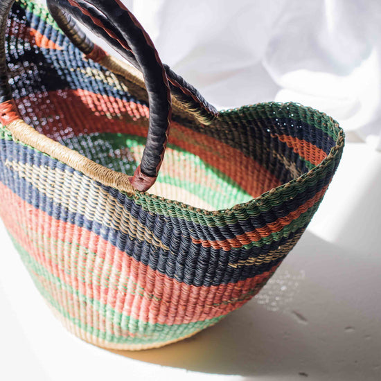 Multicolored woven basket on a white surface