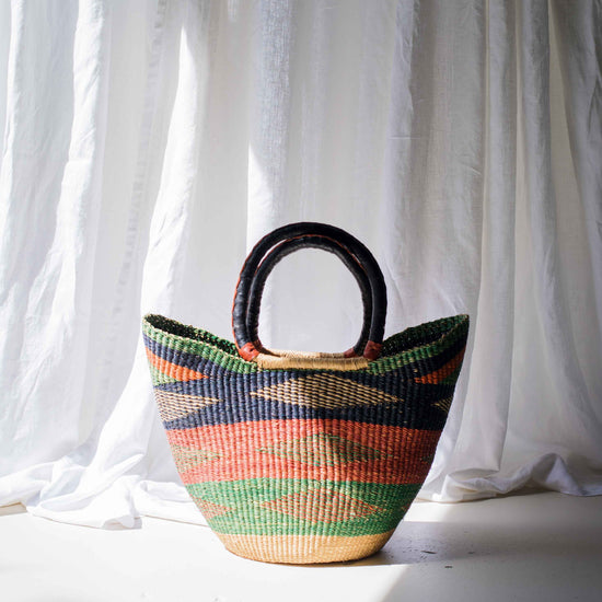Woven basket with colorful patterns on a white background
