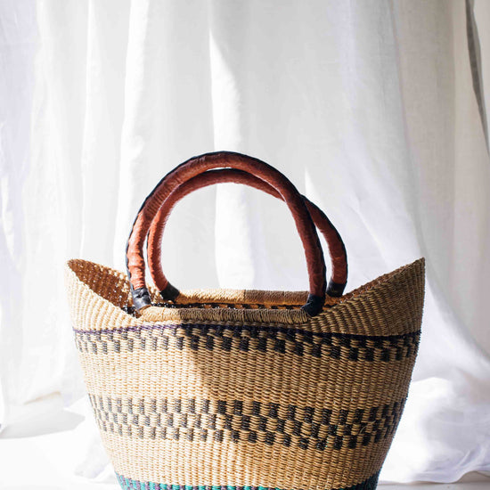 Woven basket with striped pattern on a white background
