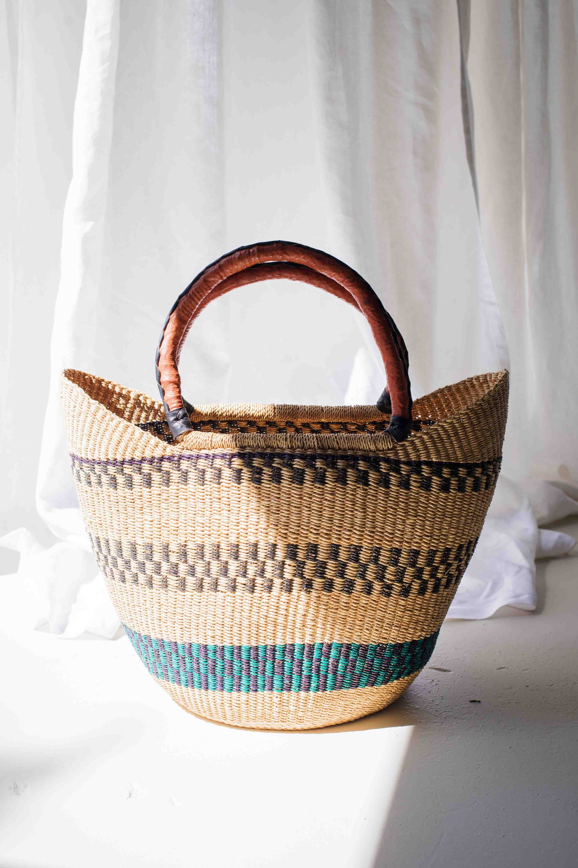 Woven basket with a wooden handle on a white background