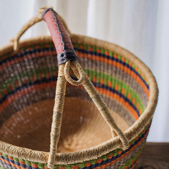 Woven basket with colorful rim on a wooden surface