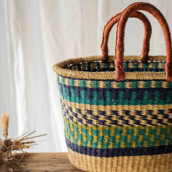 Woven basket with striped pattern on a wooden surface