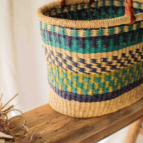 Woven basket with colorful pattern on a wooden surface