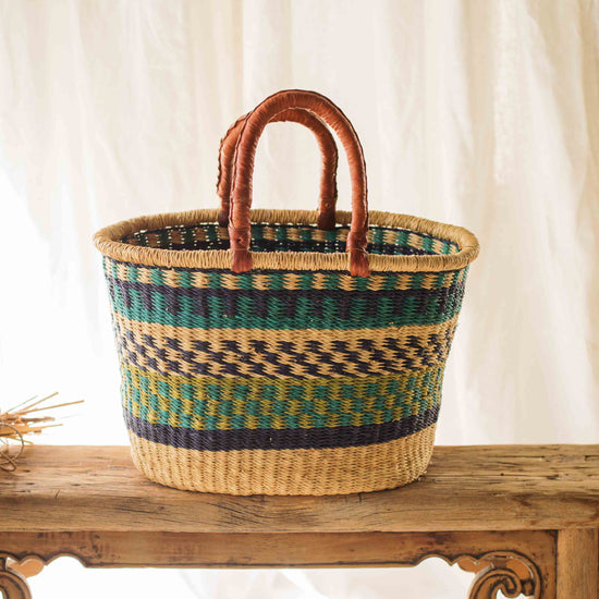 Woven basket with striped pattern on a wooden surface