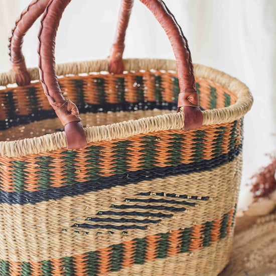 Woven basket with striped pattern on a wooden surface