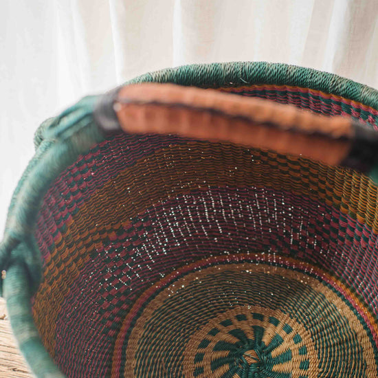 Close-up of a woven basket with intricate patterns on a white background