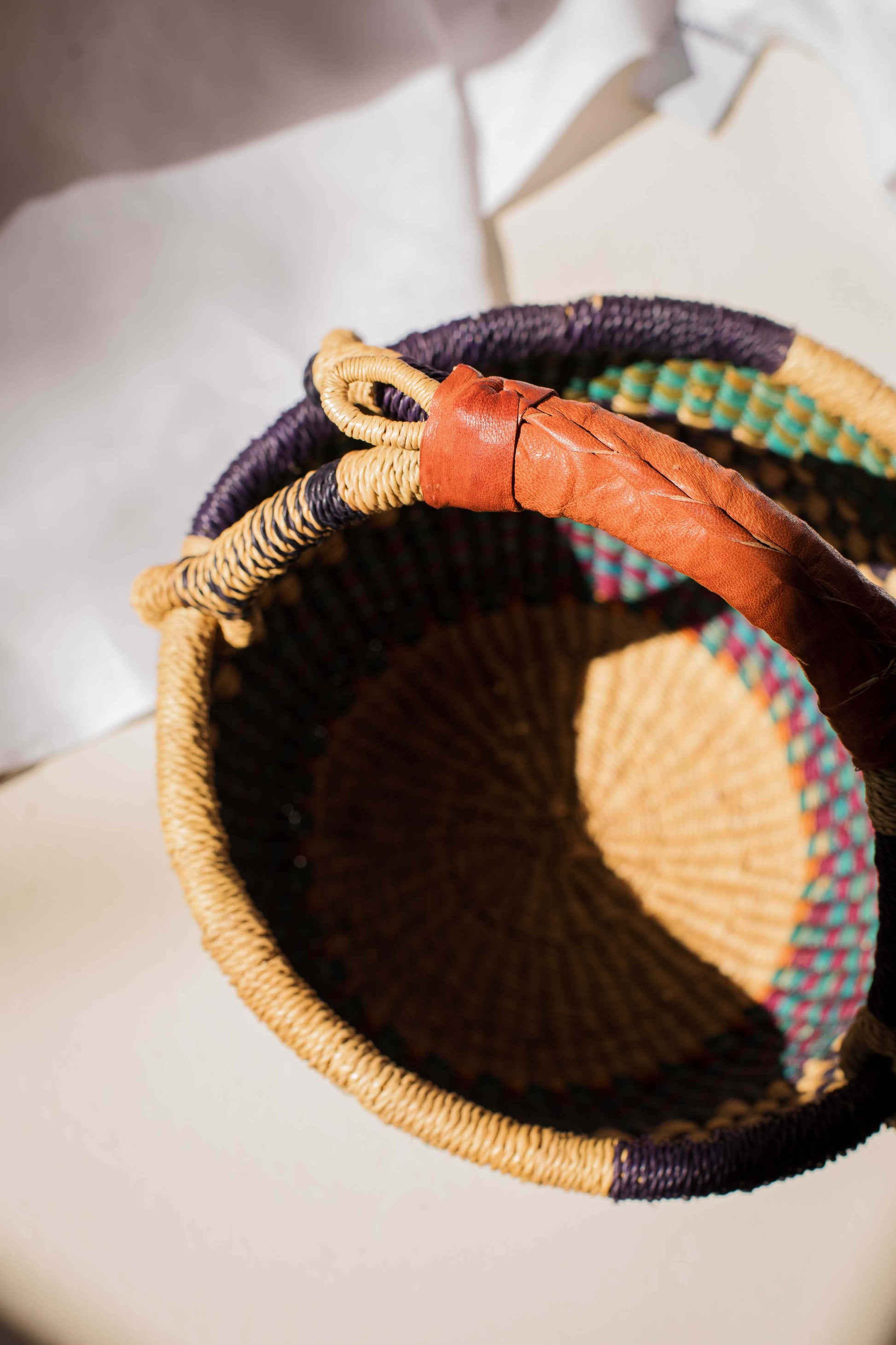 Woven basket with colorful patterns on a light background