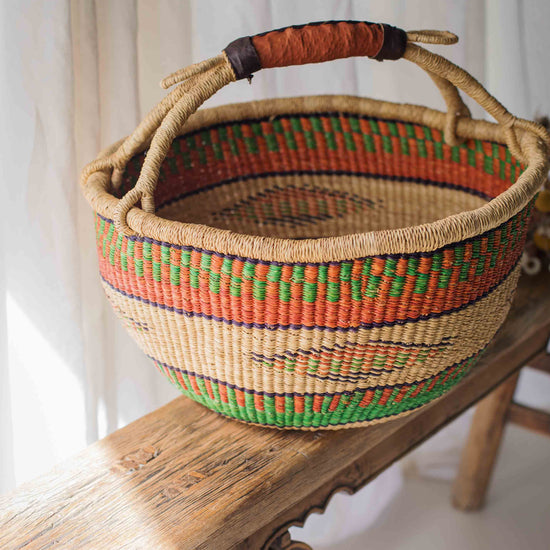 Woven basket with colorful patterns on a wooden surface